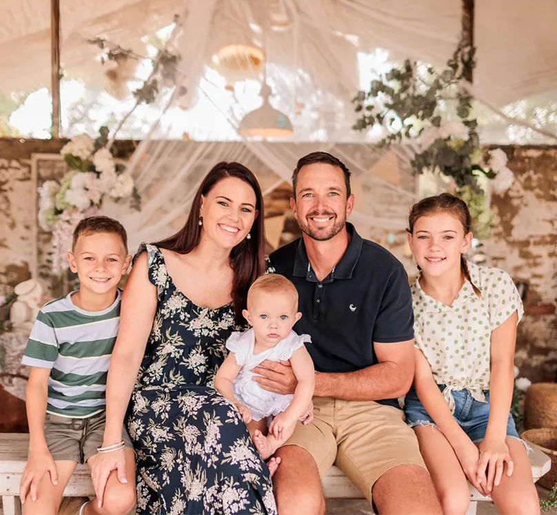 Jurgens "Yogi" Potgieter and his family—wife and three children—seated together under a decorated canopy.
