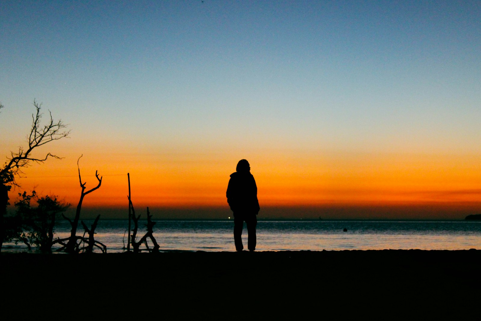 Silhouette of a person on a Mozambique beach at sunset